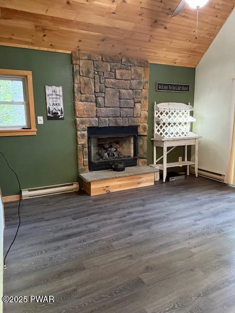 1030 Evergreen Dr, Lake Ariel, PA 18436 - unfurnished living room featuring baseboard heating, wood ceiling, a stone fireplace, wood finished floors, and vaulted ceiling