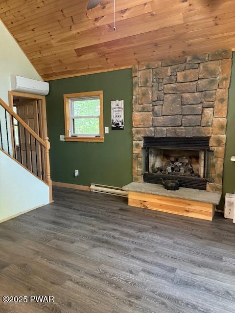 1030 Evergreen Dr, Lake Ariel, PA 18436 - unfurnished living room featuring a wall mounted air conditioner, vaulted ceiling, wood finished floors, wooden ceiling, and a stone fireplace