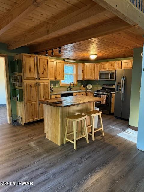 1030 Evergreen Dr, Lake Ariel, PA 18436 - kitchen with stainless steel appliances, wood ceiling with exposed beams, a kitchen island, a sink, and dark wood finished floors