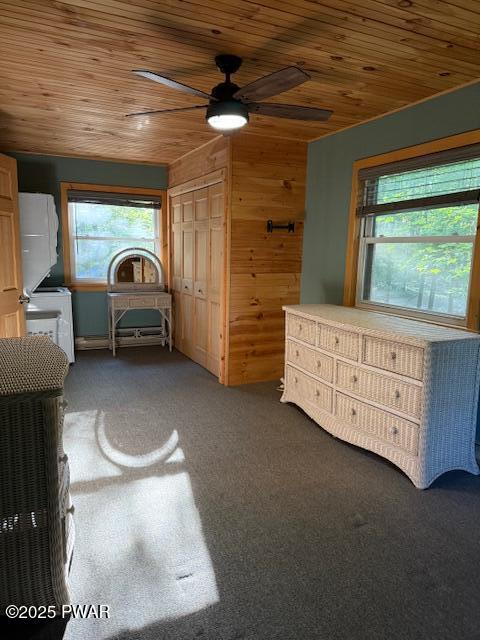1030 Evergreen Dr, Lake Ariel, PA 18436 - bedroom featuring wood ceiling, multiple windows, carpet flooring, wood walls, and ceiling fan