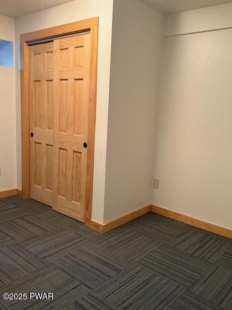 1030 Evergreen Dr, Lake Ariel, PA 18436 - unfurnished bedroom featuring dark colored carpet, a closet, and baseboards