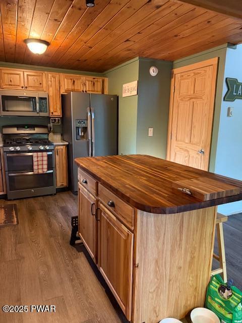 1030 Evergreen Dr, Lake Ariel, PA 18436 - kitchen featuring appliances with stainless steel finishes, wooden counters, wooden ceiling, dark wood-type flooring, and a center island