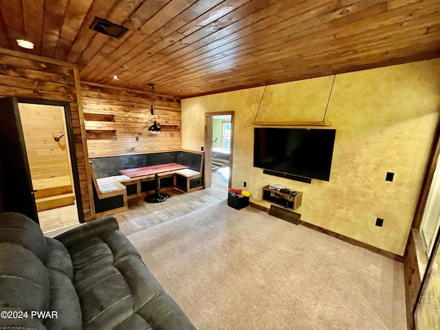 living room with carpet, wood walls, and wooden ceiling