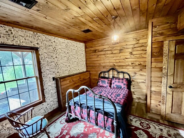 bedroom with hardwood / wood-style flooring and wood ceiling