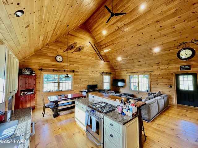 kitchen featuring high end range, high vaulted ceiling, white cabinets, wood ceiling, and light wood-type flooring