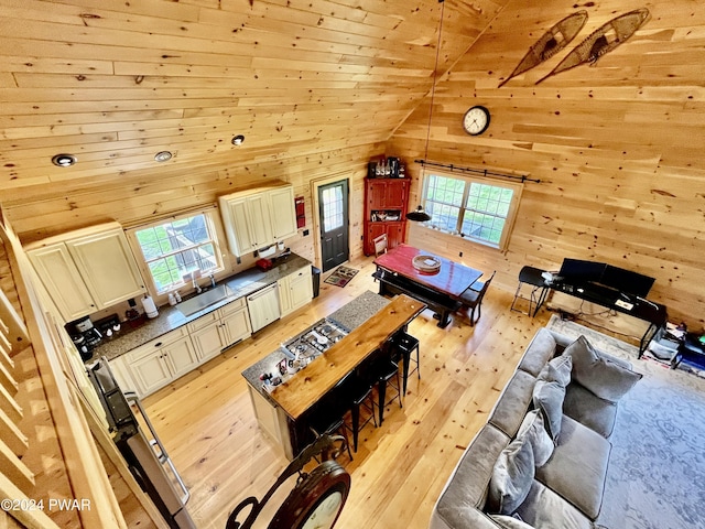 living room featuring plenty of natural light, high vaulted ceiling, wooden ceiling, and light wood-type flooring