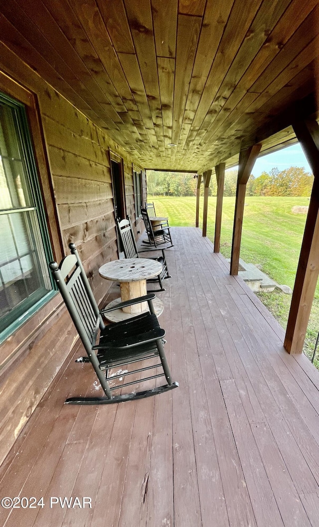 wooden deck featuring a yard and a porch