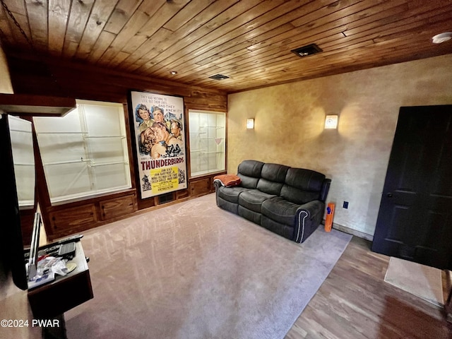 cinema room featuring hardwood / wood-style floors, wooden ceiling, and wood walls