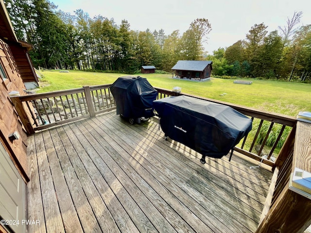 wooden terrace with an outbuilding and grilling area