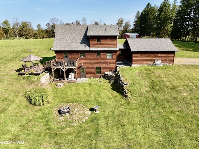 back of house with a yard and a deck