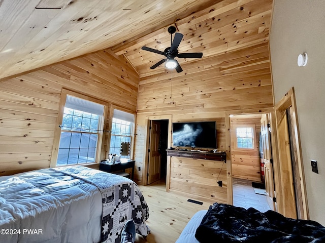 bedroom featuring multiple windows, wood walls, ceiling fan, and wooden ceiling