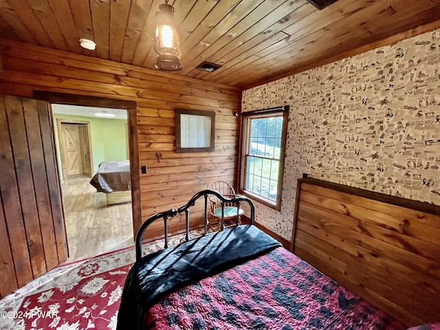 bedroom featuring wood walls and wooden ceiling