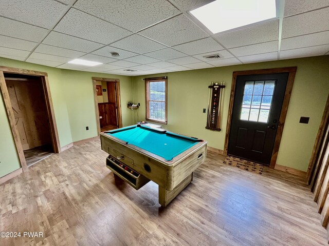 game room with light hardwood / wood-style floors, a drop ceiling, a healthy amount of sunlight, and pool table