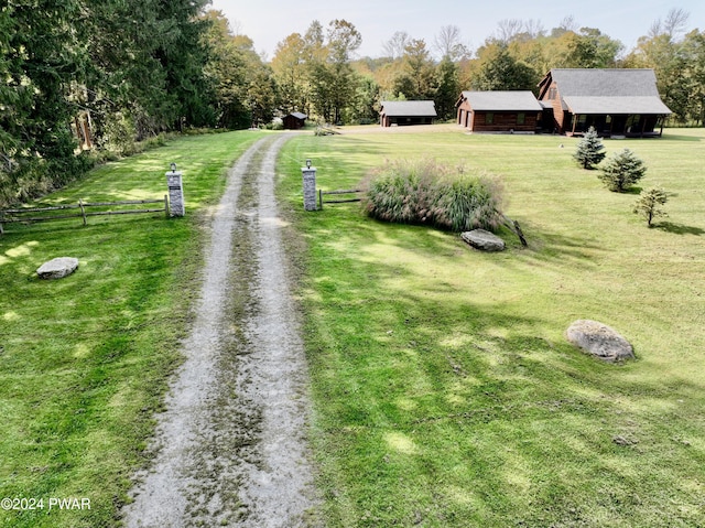 view of community featuring a lawn and a rural view