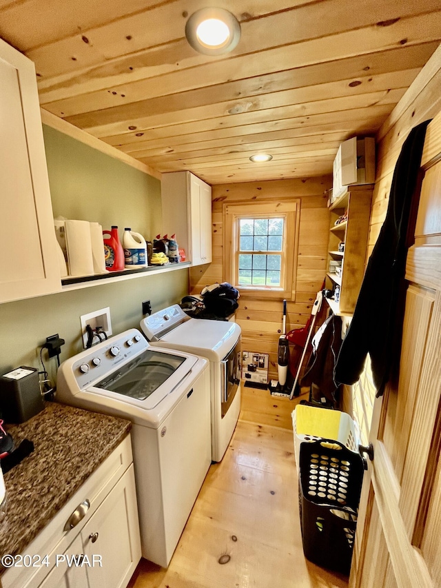 laundry room featuring cabinets, independent washer and dryer, light wood-type flooring, and wood ceiling