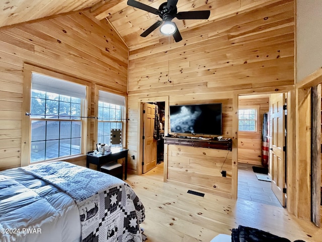 bedroom featuring wood walls, high vaulted ceiling, ceiling fan, beamed ceiling, and light hardwood / wood-style floors