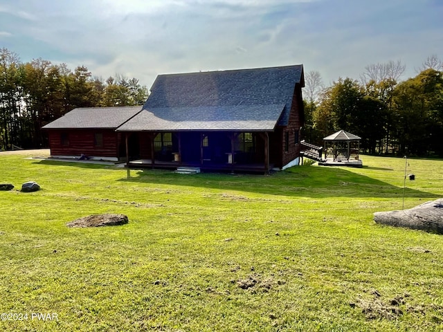 back of house with a gazebo and a lawn