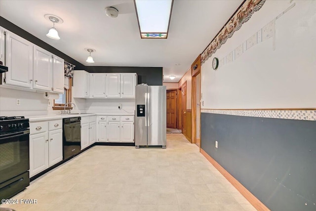 kitchen with black appliances, white cabinets, ventilation hood, and sink