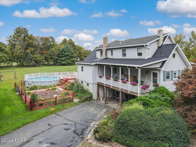 rear view of house with a yard and a garage