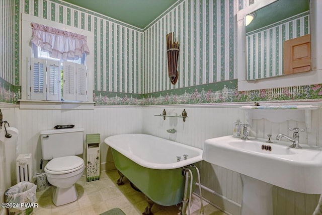 bathroom with toilet, a tub, and sink