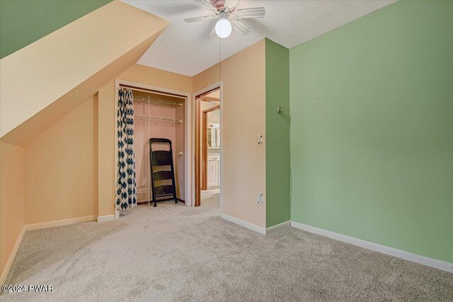 bonus room with light colored carpet, vaulted ceiling, and ceiling fan