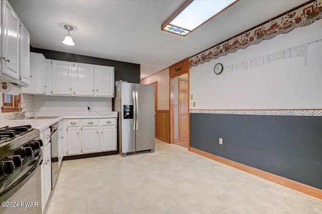 kitchen with sink, white cabinetry, and stainless steel appliances