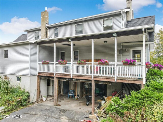 back of property with a wooden deck