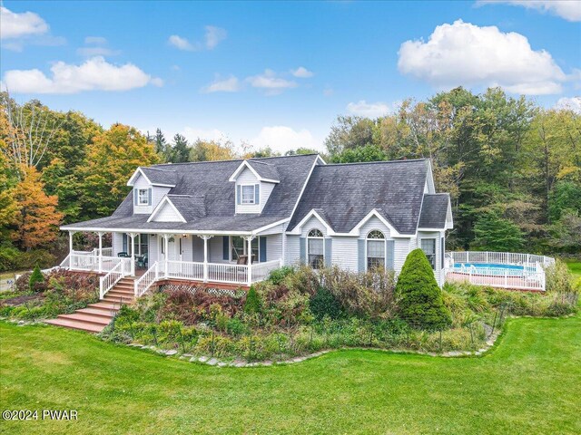 cape cod home featuring covered porch and a front yard