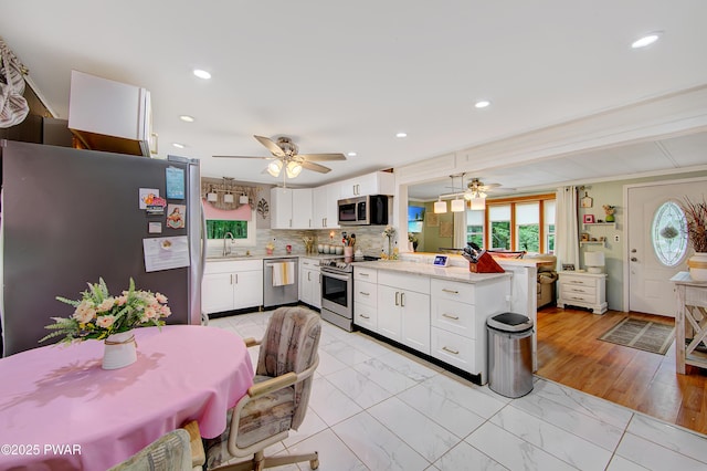 202 Fox Rd, Dingmans Ferry, PA 18328 - kitchen featuring appliances with stainless steel finishes, a ceiling fan, a peninsula, white cabinetry, and recessed lighting