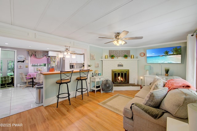 202 Fox Rd, Dingmans Ferry, PA 18328 - living room featuring a ceiling fan, a fireplace, and light wood-style floors