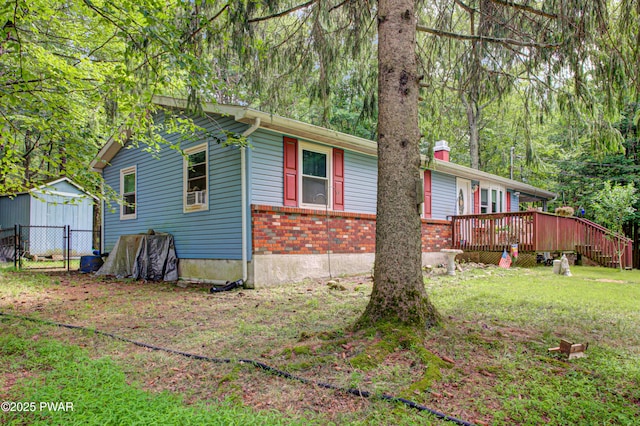 202 Fox Rd, Dingmans Ferry, PA 18328 - view of home's exterior with a deck and brick siding