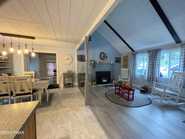 living room with light wood-type flooring, wood ceiling, a fireplace, and vaulted ceiling