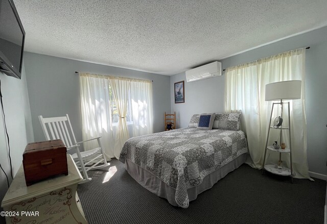 carpeted bedroom with a wall mounted air conditioner and a textured ceiling