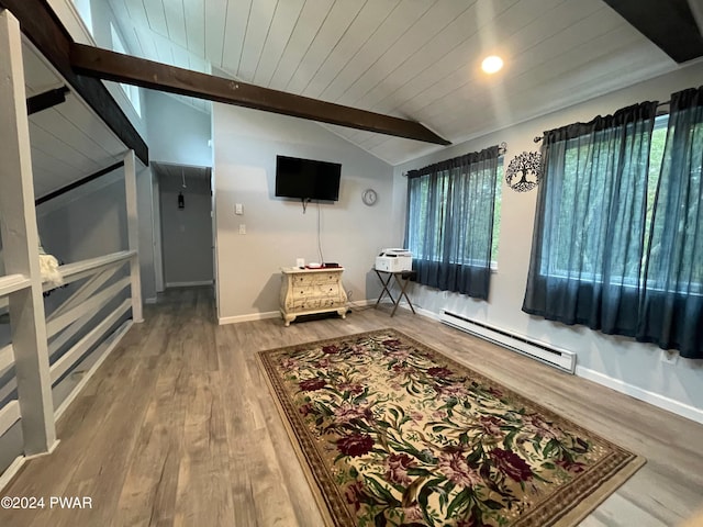 interior space with wood ceiling, baseboard heating, a healthy amount of sunlight, lofted ceiling with beams, and hardwood / wood-style flooring