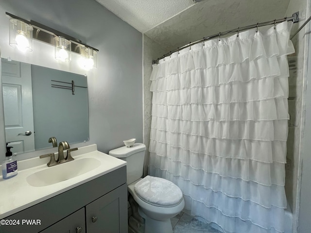 bathroom featuring vanity, curtained shower, toilet, and a textured ceiling