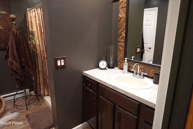 132 N Lake Shore Dr, Dingmans Ferry, PA 18328 - full bath with vanity, baseboard heating, a shower with shower curtain, and wood finished floors