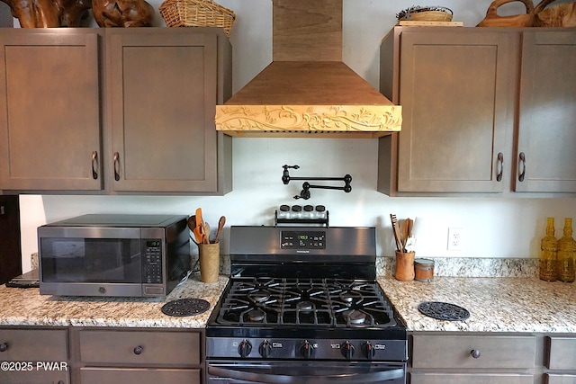 132 N Lake Shore Dr, Dingmans Ferry, PA 18328 - kitchen with appliances with stainless steel finishes, custom exhaust hood, and light stone countertops