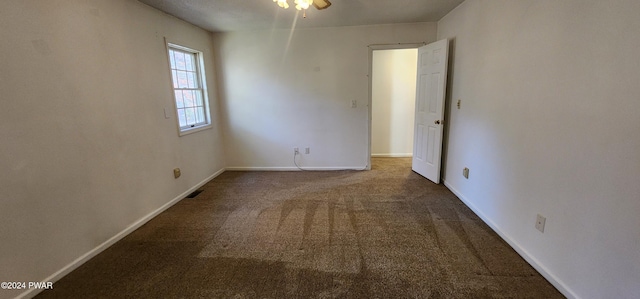 carpeted empty room with ceiling fan