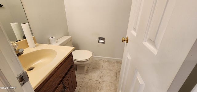 bathroom with tile patterned flooring, vanity, and toilet