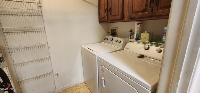 washroom with cabinets and washer and clothes dryer