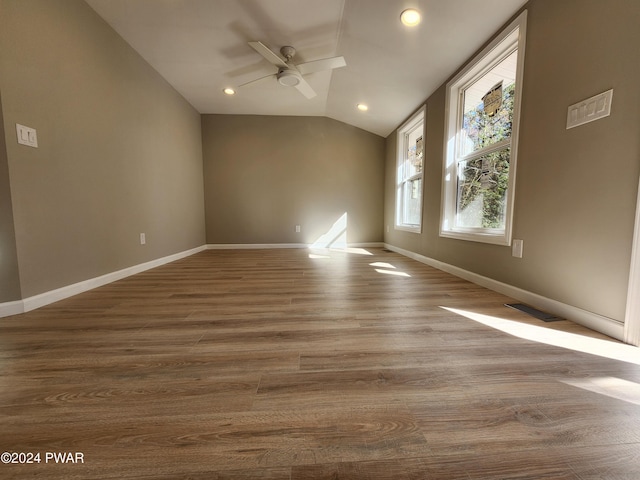 spare room with hardwood / wood-style floors, ceiling fan, and vaulted ceiling