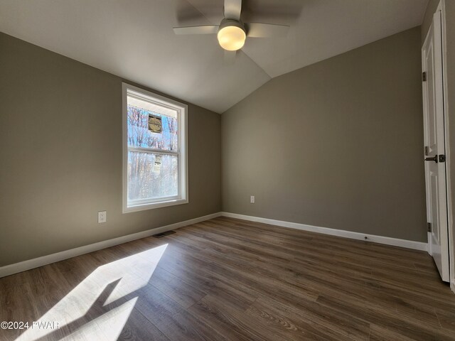 interior space featuring ceiling fan, dark hardwood / wood-style flooring, and lofted ceiling