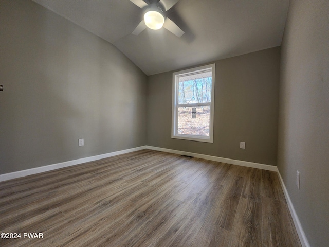 spare room featuring hardwood / wood-style flooring, ceiling fan, and lofted ceiling