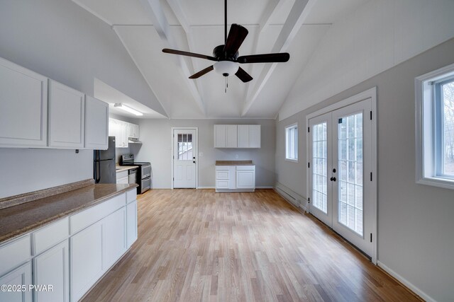 kitchen with white cabinetry, stainless steel range with electric cooktop, a wealth of natural light, and french doors