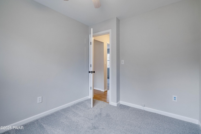 unfurnished room with carpet flooring and ceiling fan