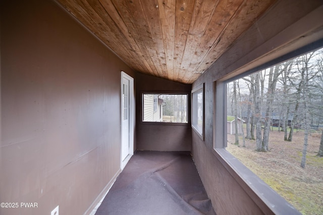 unfurnished sunroom featuring wood ceiling and vaulted ceiling