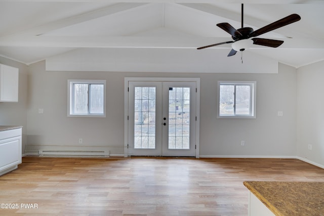 interior space with vaulted ceiling with beams, plenty of natural light, baseboard heating, and french doors