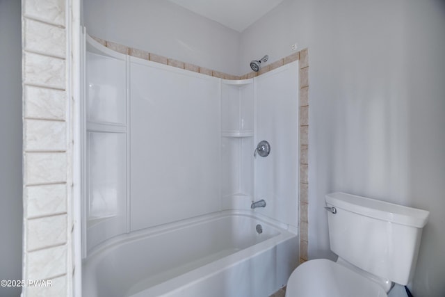 bathroom with toilet and bathing tub / shower combination