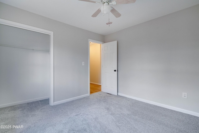 unfurnished bedroom with ceiling fan, carpet floors, and a closet