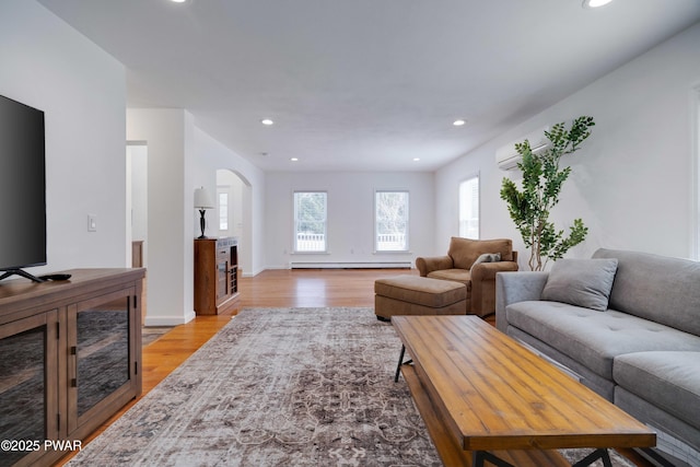 living room with light wood-type flooring and baseboard heating